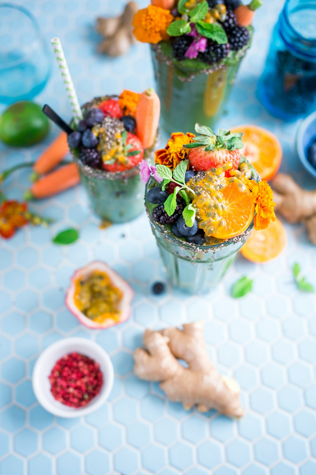 Too much fruit in the fridge meant it was time to make a smoothie. In went everything. And I mean, everything: kale, arugula, berries, oranges, mint, ginger, chia seeds, honey. Blend. Serve. So happy. by Camping Checklist tilt shift lens photography of fruits in drinking glass