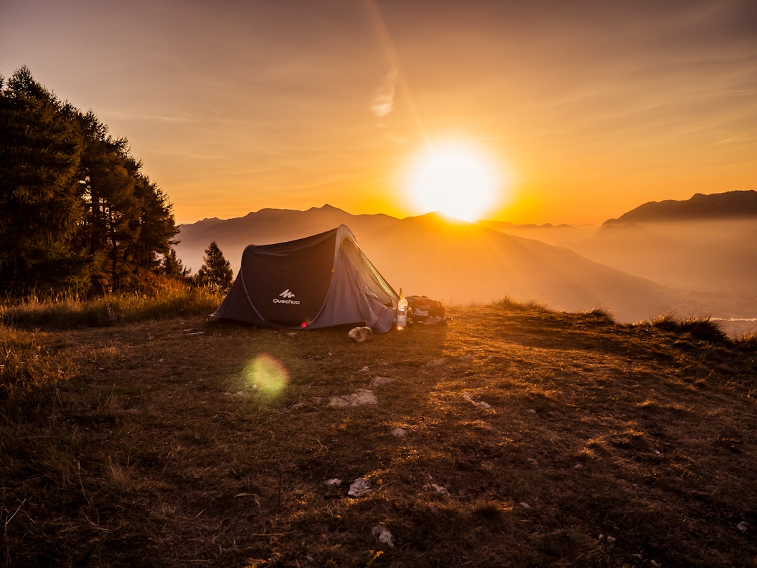 Before the Night by Camping Checklist dome tent on mountain top with sun as background photo