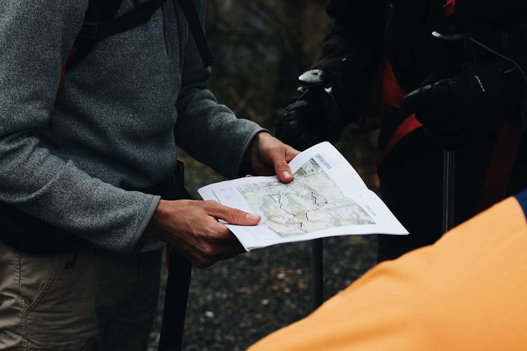 Conclusion: Your Preparedness, Your Adventure! ✅ by Camping Checklist person in gray coat holding white printer paper