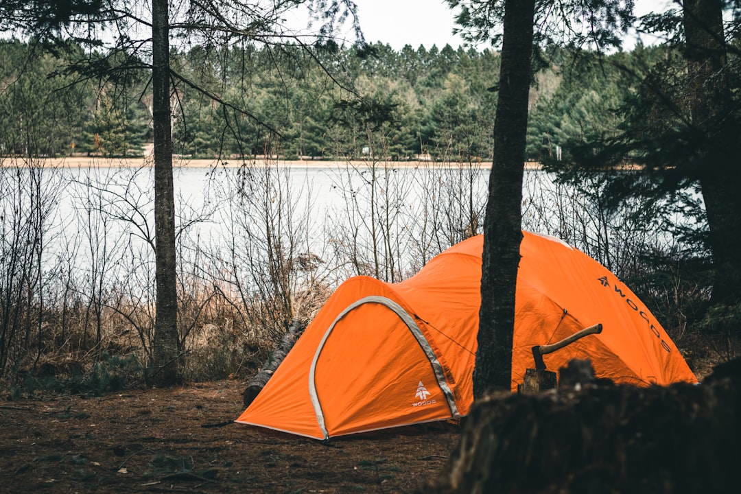 Camping in the fall by Camping Checklist a tent on a rock by a lake